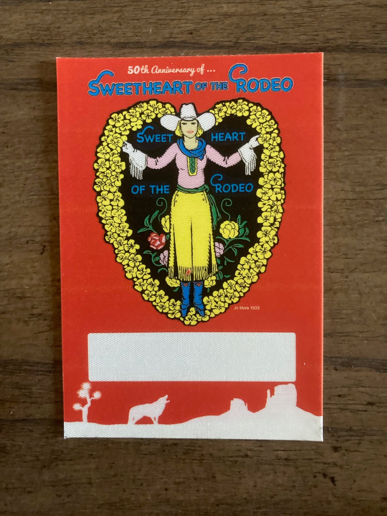 Vintage-style card with colorful design on a wooden surface